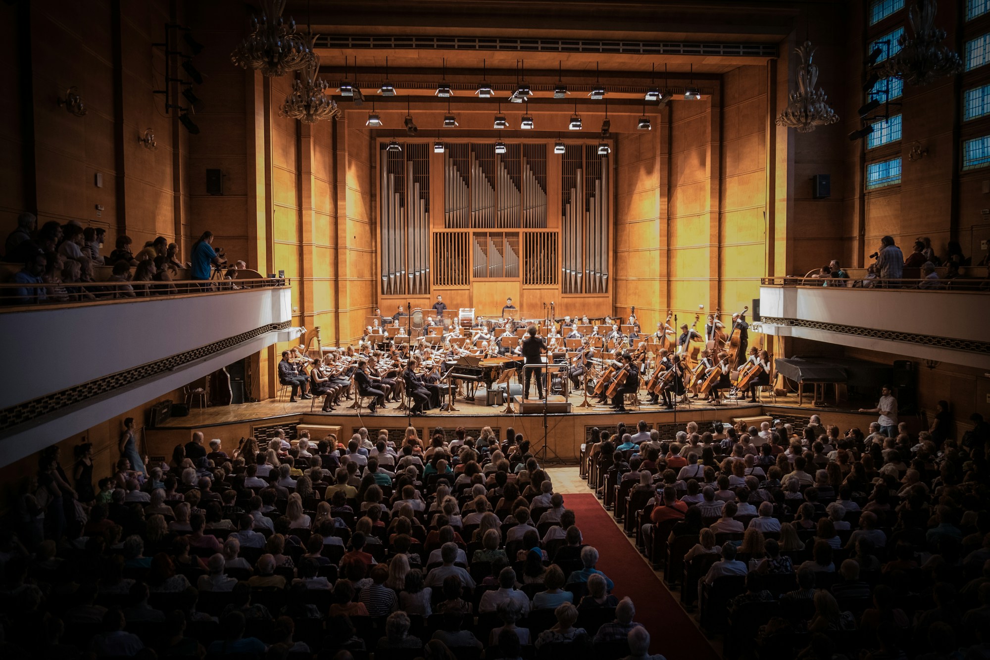 An orchestra and audience sharing a performance in a concert hall